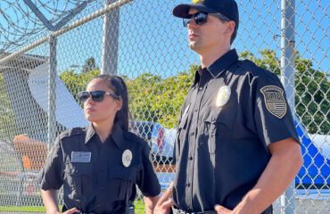 Airport security guards patrolling near perimeter fence, ensuring safe and secure travel through vigilant monitoring and access control