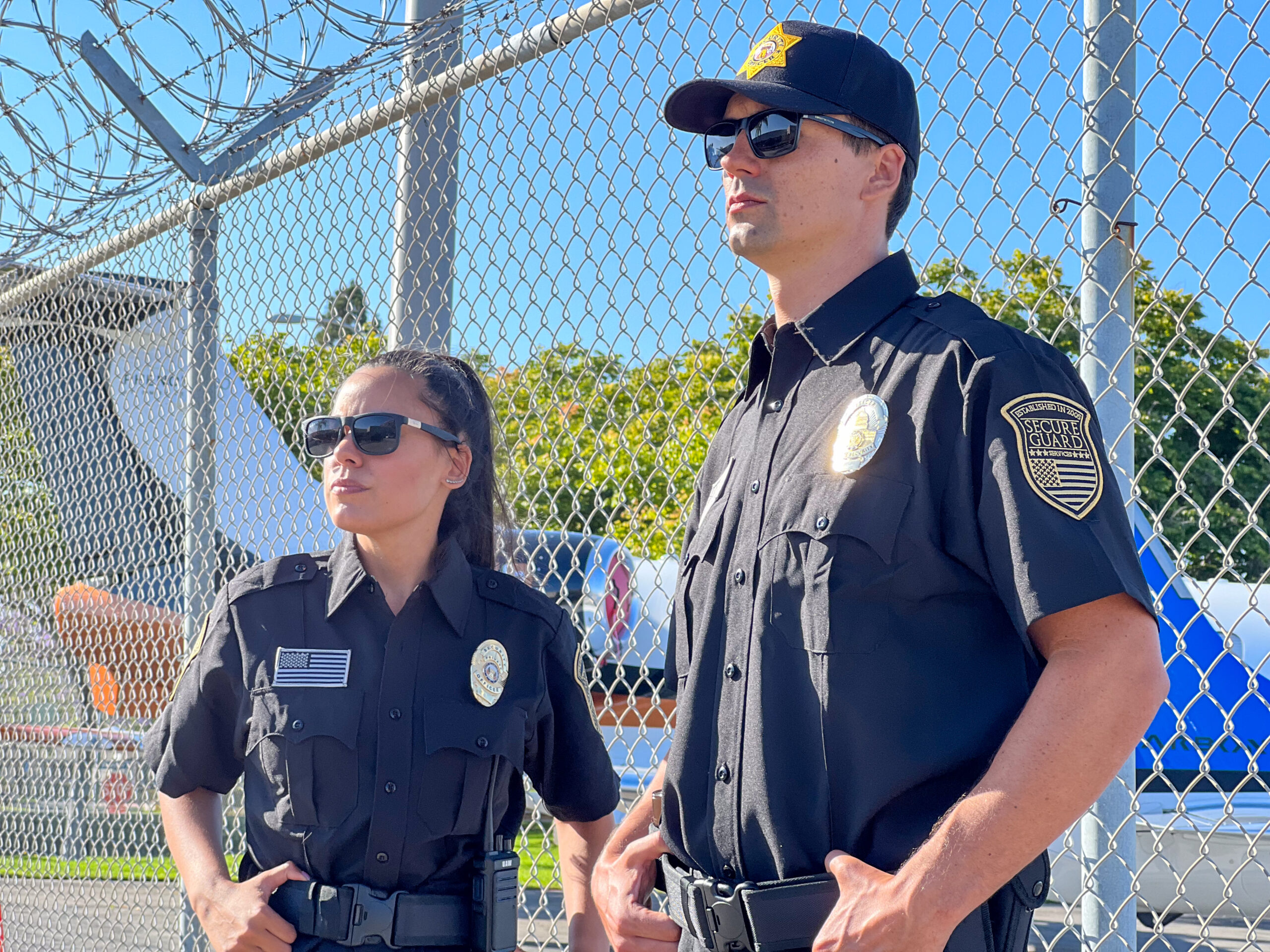 Airport security guards patrolling near perimeter fence, ensuring safe and secure travel through vigilant monitoring and access control