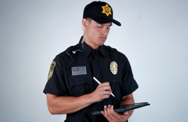 Security guard conducting a risk assessment using a tablet, identifying potential vulnerabilities in business security systems