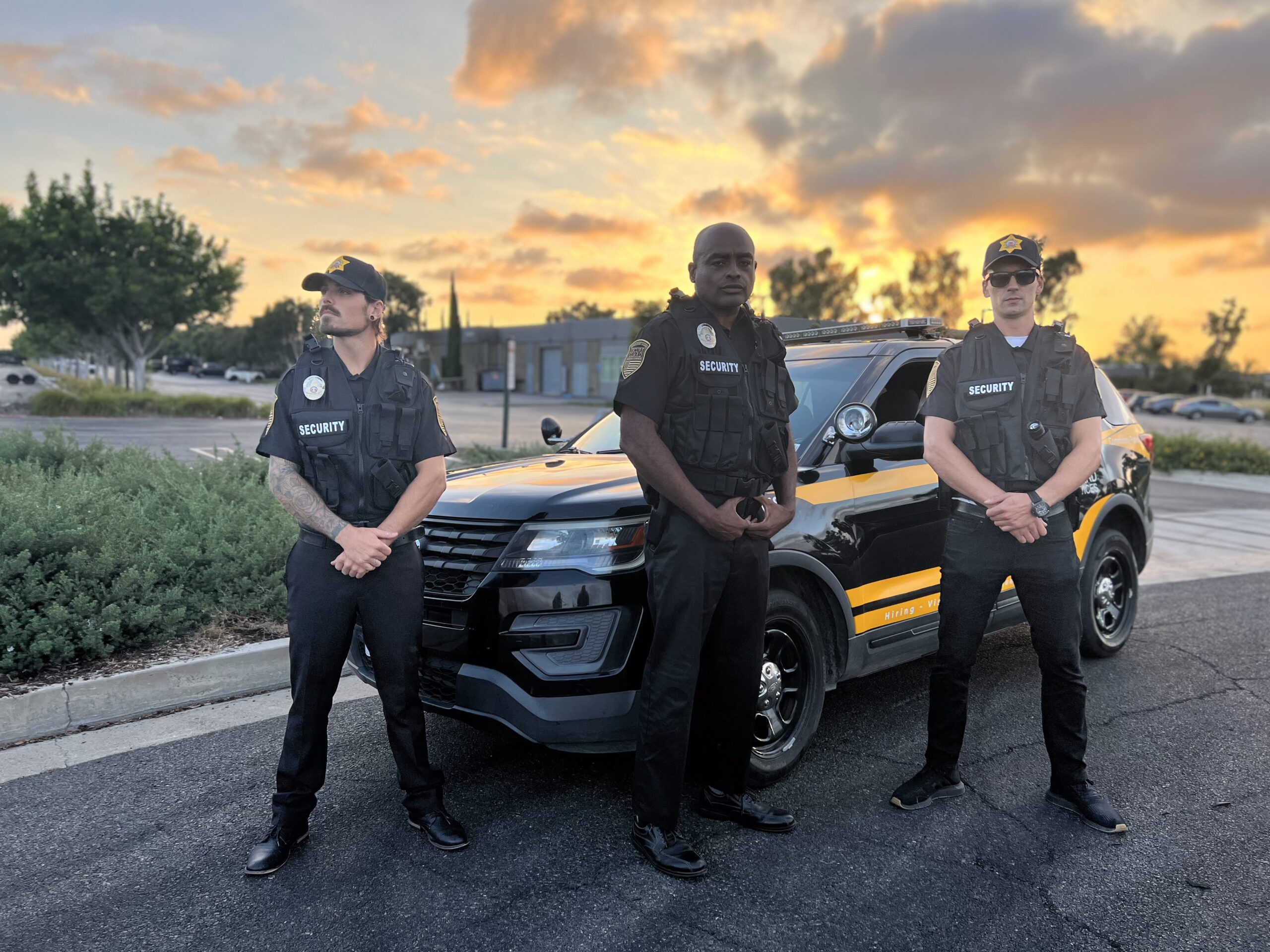 Alert security guard in uniform scanning surroundings outside a building, highlighting visible deterrence and common vulnerabilities criminals look for