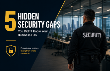 Security guard standing inside a modern office building beside text reading “5 Hidden Security Gaps You Didn’t Know Your Business Has,” highlighting business security vulnerabilities and risk prevention.