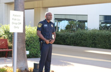 Hospital security guard monitoring patient pick-up and drop-off area to maintain safety and access control at a healthcare facility