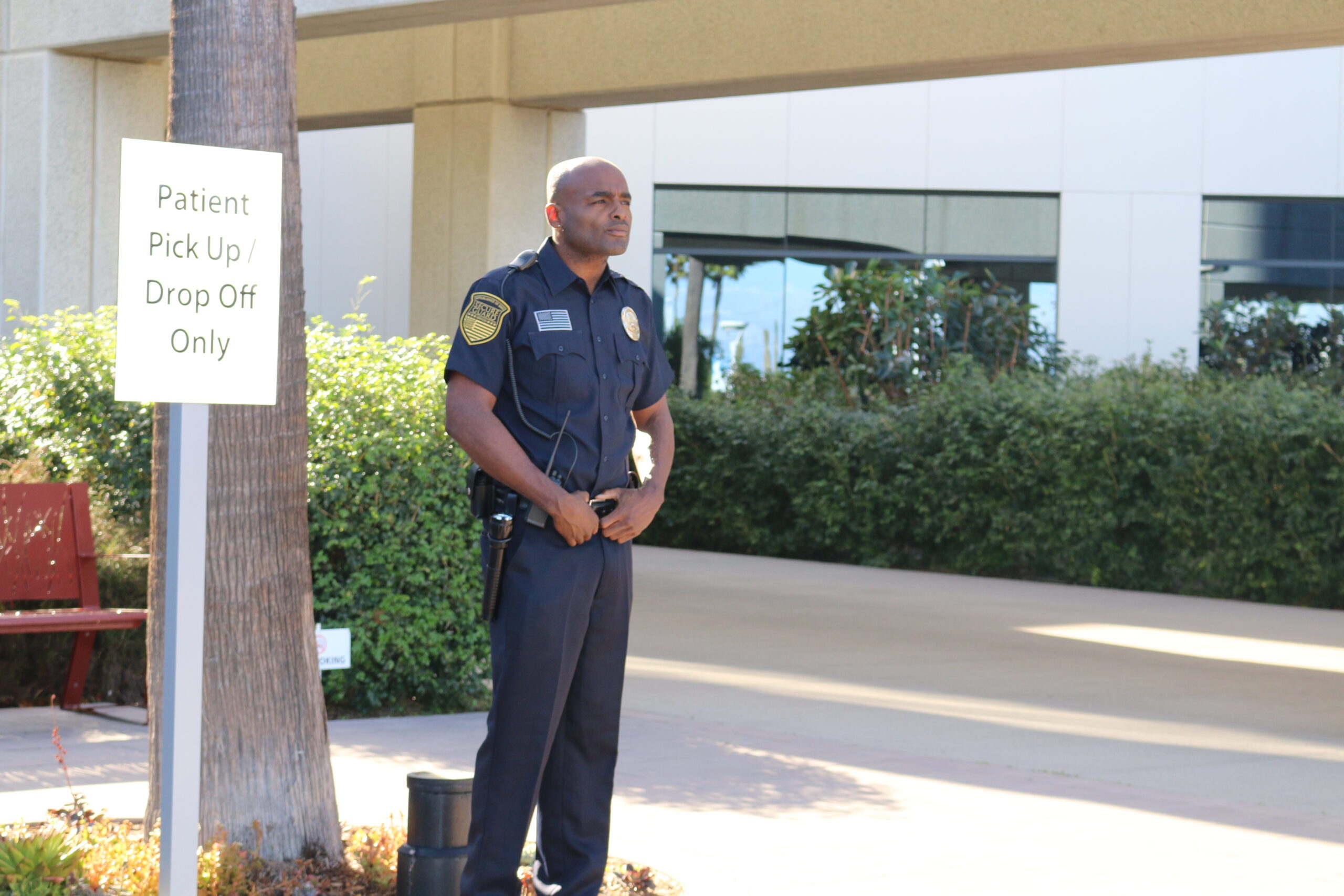 Hospital security guard monitoring patient pick-up and drop-off area to maintain safety and access control at a healthcare facility