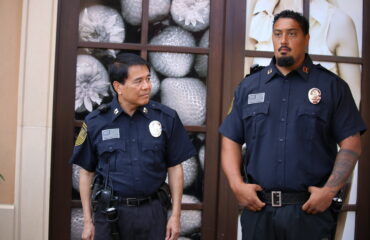 Two professional security guards standing outside a commercial building in Santa Ana, providing visible security presence and protection for businesses, employees, and visitors.